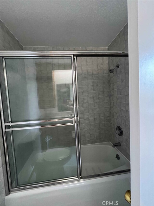 28714 Cruthers Creek Rd, Pearblossom, CA 93553 - full bathroom featuring shower / bath combination with glass door and a textured ceiling