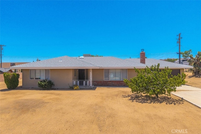 7535 Hilton Ave, Yucca Valley, CA 92284 - ranch-style house with concrete driveway, an attached garage, and stucco siding