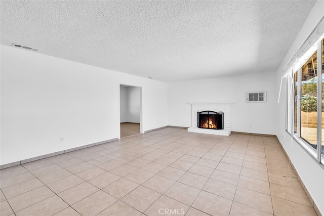 7535 Hilton Ave, Yucca Valley, CA 92284 - unfurnished living room featuring a textured ceiling and a fireplace