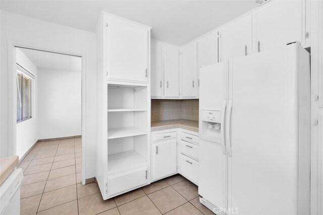 7535 Hilton Ave, Yucca Valley, CA 92284 - kitchen featuring white appliances, light countertops, light tile patterned floors, white cabinets, and tasteful backsplash