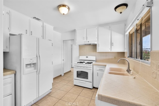 7535 Hilton Ave, Yucca Valley, CA 92284 - kitchen with white appliances, under cabinet range hood, backsplash, and white cabinetry