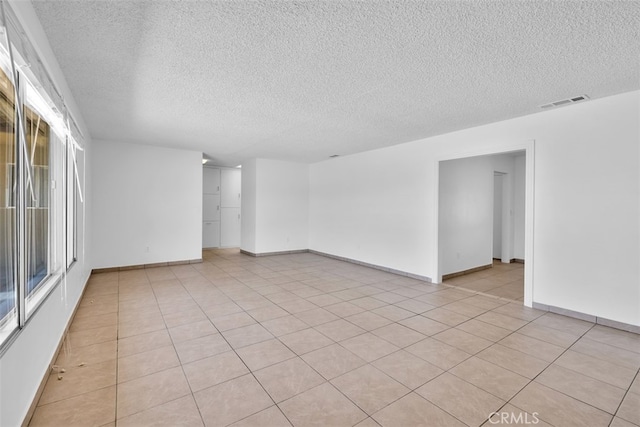 7535 Hilton Ave, Yucca Valley, CA 92284 - spare room with a textured ceiling and light tile patterned flooring