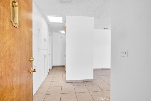 7535 Hilton Ave, Yucca Valley, CA 92284 - hallway featuring light tile patterned floors and a textured ceiling