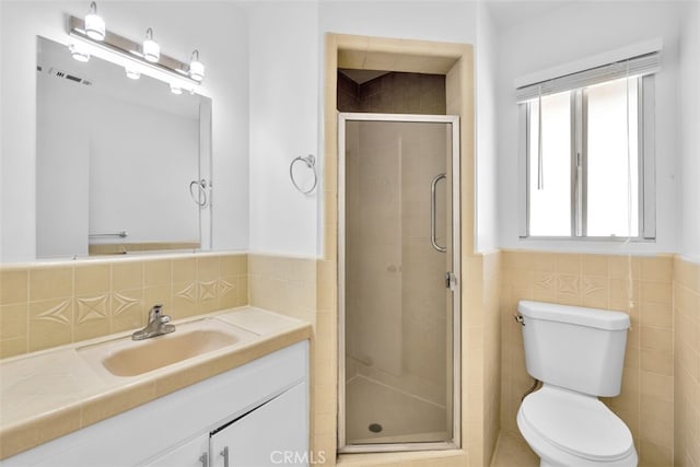 7535 Hilton Ave, Yucca Valley, CA 92284 - bathroom with vanity, tile walls, a shower stall, and wainscoting