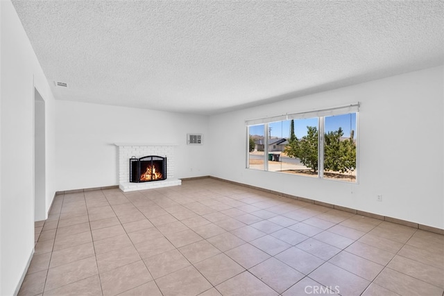 7535 Hilton Ave, Yucca Valley, CA 92284 - unfurnished living room with a textured ceiling, a fireplace, and tile patterned flooring