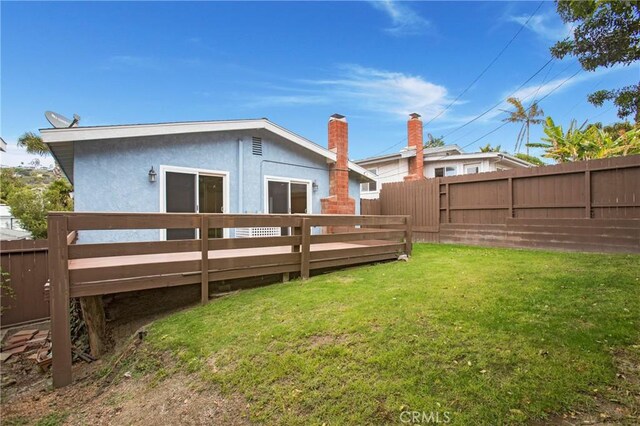34561 Calle Portola, Dana Point, CA 92624 - back of property with a fenced backyard, stucco siding, a deck, and a chimney