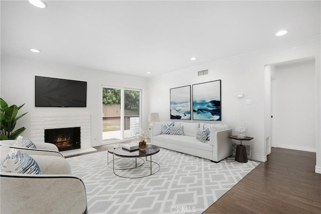 34561 Calle Portola, Dana Point, CA 92624 - living area featuring wood finished floors, recessed lighting, a brick fireplace, and crown molding