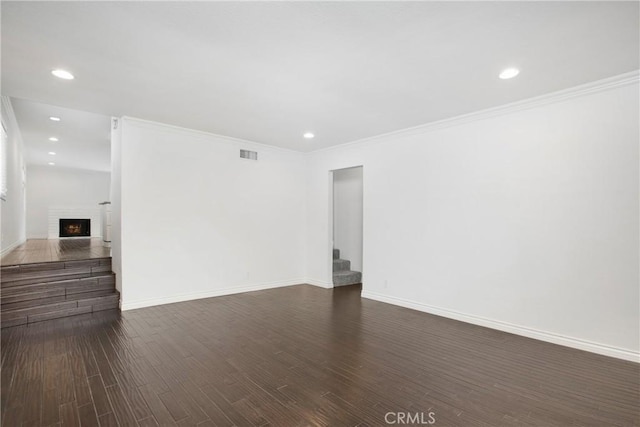 34561 Calle Portola, Dana Point, CA 92624 - unfurnished living room with stairway, dark wood-style flooring, recessed lighting, a fireplace, and crown molding