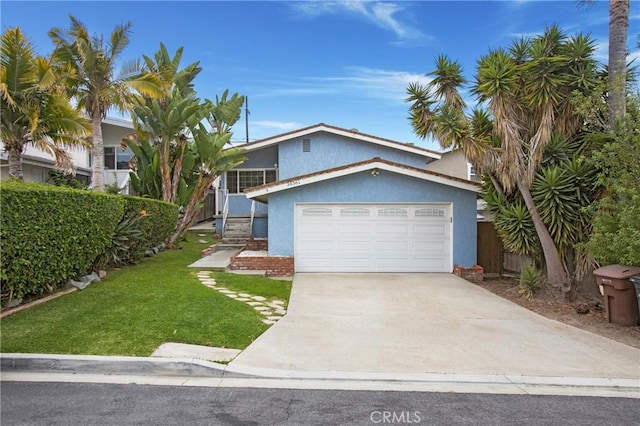 34561 Calle Portola, Dana Point, CA 92624 - view of front facade with stucco siding, a front yard, an attached garage, and driveway