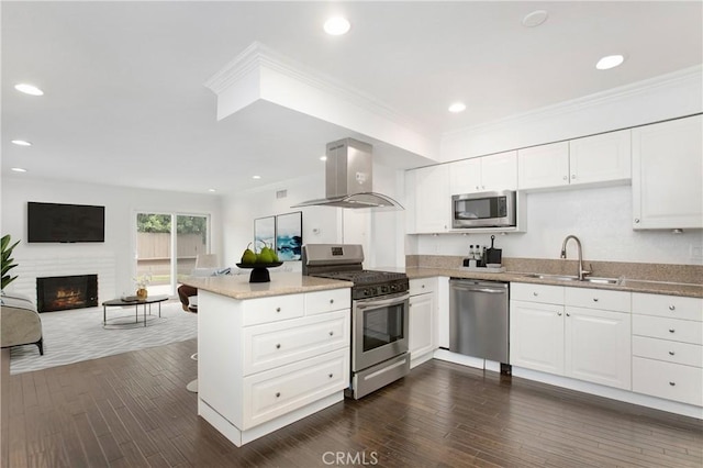 34561 Calle Portola, Dana Point, CA 92624 - kitchen with stainless steel appliances, island range hood, white cabinetry, a peninsula, and ornamental molding