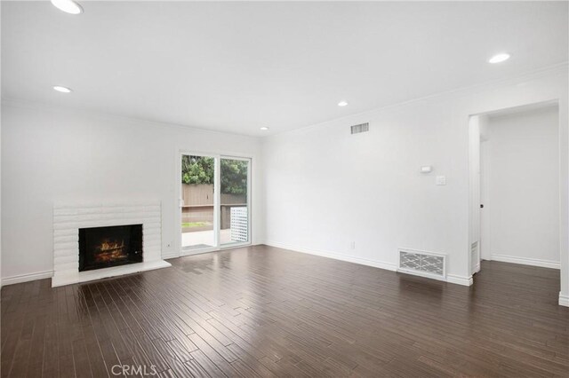 34561 Calle Portola, Dana Point, CA 92624 - unfurnished living room featuring a fireplace, crown molding, dark wood-style floors, and recessed lighting