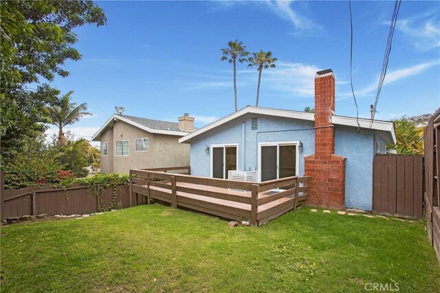 34561 Calle Portola, Dana Point, CA 92624 - rear view of house featuring a chimney, a fenced backyard, stucco siding, and a deck