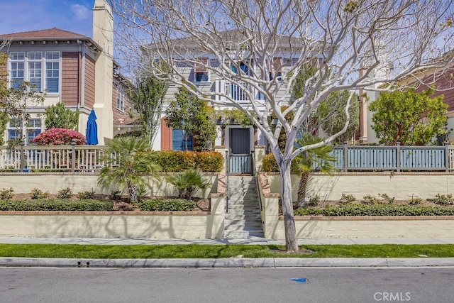 2569 Bungalow Pl, Corona Del Mar, CA 92625 - view of front of home with a fenced front yard and a chimney