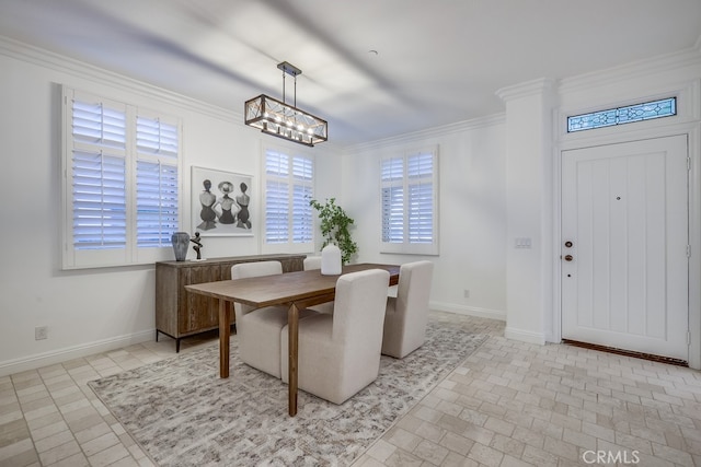 2569 Bungalow Pl, Corona Del Mar, CA 92625 - dining space featuring crown molding, a chandelier, and brick patterned flooring