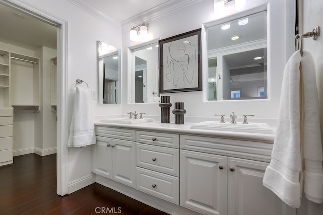 2569 Bungalow Pl, Corona Del Mar, CA 92625 - bathroom with double vanity, ornamental molding, and wood finished floors
