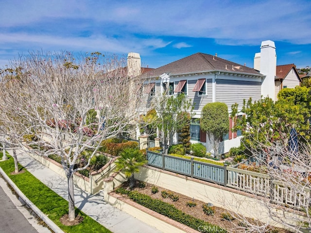 2569 Bungalow Pl, Corona Del Mar, CA 92625 - view of side of property with a chimney and roof with shingles