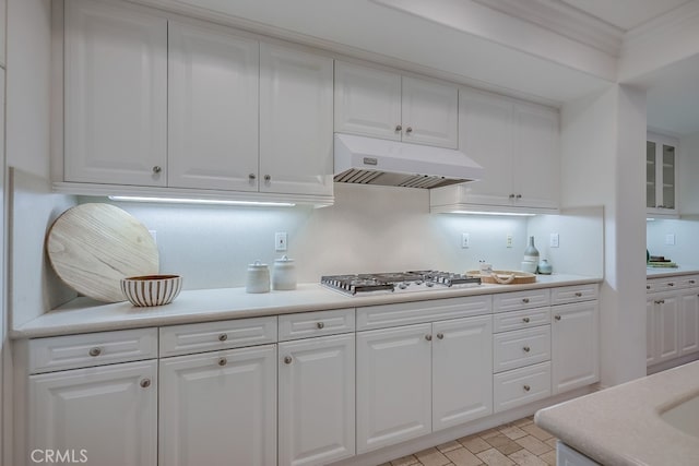 2569 Bungalow Pl, Corona Del Mar, CA 92625 - kitchen with under cabinet range hood, stainless steel gas stovetop, white cabinetry, and light countertops
