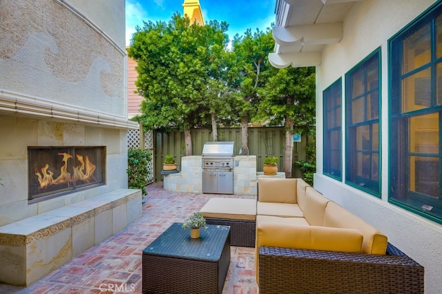 2569 Bungalow Pl, Corona Del Mar, CA 92625 - view of patio / terrace featuring an outdoor living space with a fireplace and an outdoor kitchen