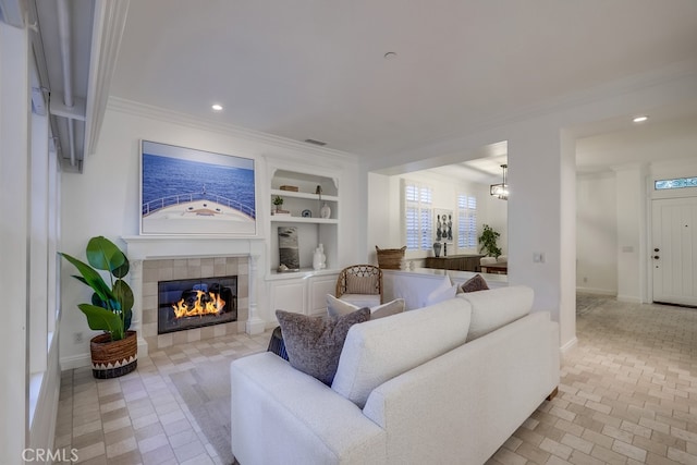 2569 Bungalow Pl, Corona Del Mar, CA 92625 - living area with crown molding, a tiled fireplace, built in shelves, and recessed lighting