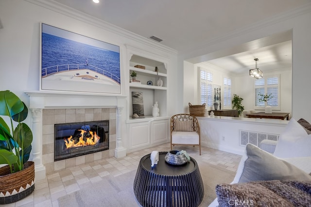 2569 Bungalow Pl, Corona Del Mar, CA 92625 - living room featuring built in shelves, a tile fireplace, and ornamental molding