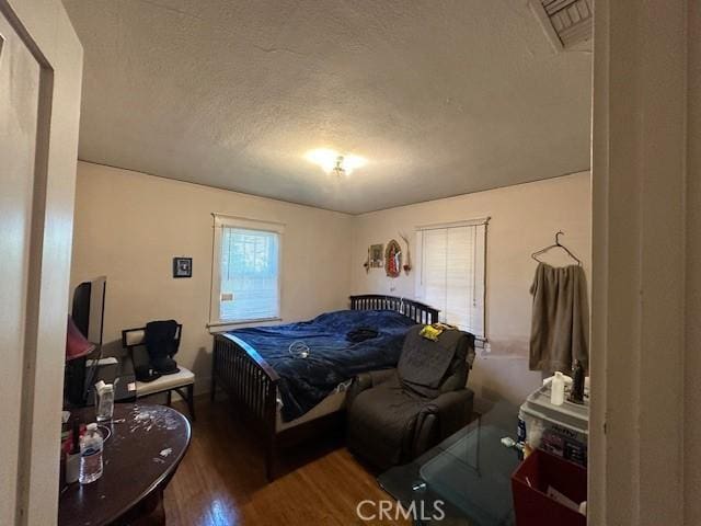 1045 Gladys Ave, Long Beach, CA 90804 - bedroom featuring a textured ceiling and wood finished floors
