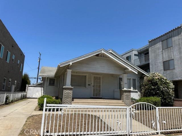 1045 Gladys Ave, Long Beach, CA 90804 - view of front facade with a porch, a fenced front yard, and a gate
