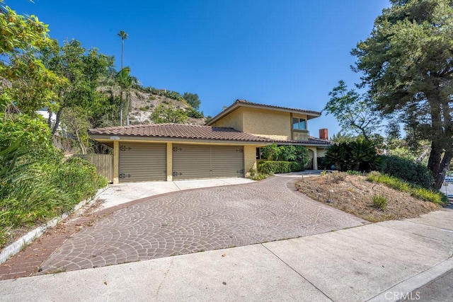 851 Misty Isle Dr, Glendale, CA 91207 - view of front of property with a tiled roof, a garage, driveway, and stucco siding