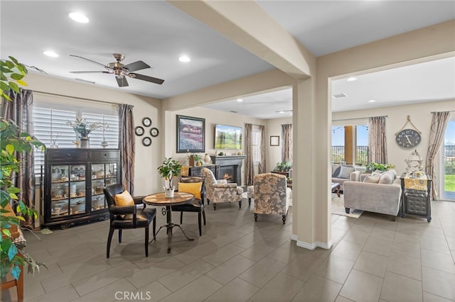 44316 Revana St, Temecula, CA 92592 - tiled dining area with a ceiling fan, healthy amount of natural light, a warm lit fireplace, and recessed lighting