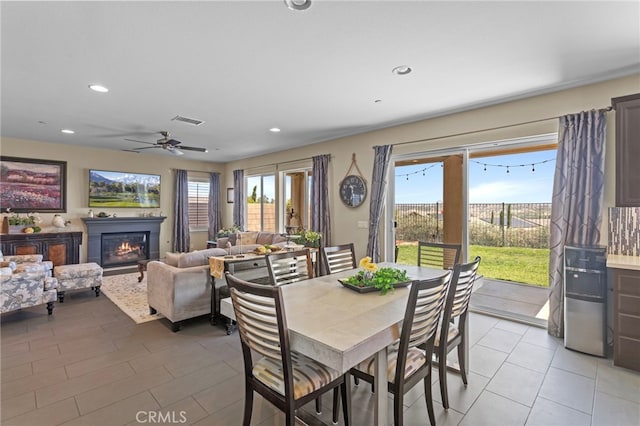 44316 Revana St, Temecula, CA 92592 - dining area featuring a glass covered fireplace, recessed lighting, light tile patterned floors, and ceiling fan