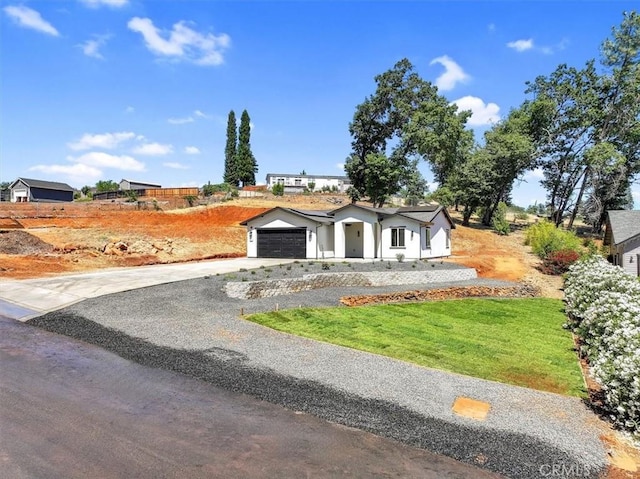 5350 Filbert St, Paradise, CA 95969 - view of front of home featuring driveway, an attached garage, and a front yard