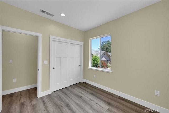 5350 Filbert St, Paradise, CA 95969 - unfurnished bedroom featuring wood finished floors, a closet, and recessed lighting