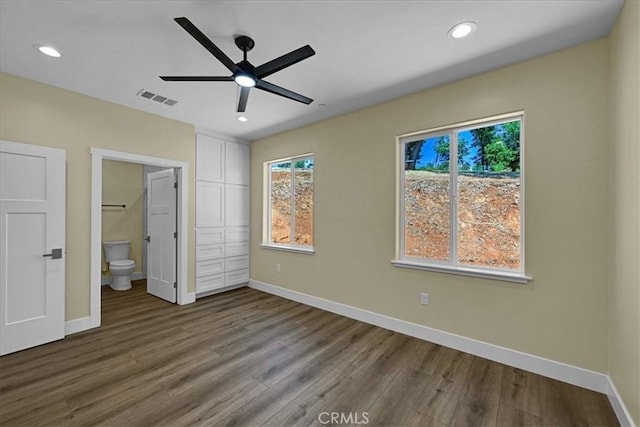 5350 Filbert St, Paradise, CA 95969 - unfurnished bedroom featuring wood finished floors, multiple windows, recessed lighting, connected bathroom, and ceiling fan