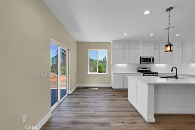 5350 Filbert St, Paradise, CA 95969 - kitchen with stainless steel appliances, light countertops, white cabinets, wood finished floors, and recessed lighting