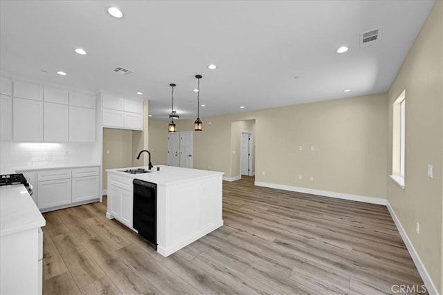 5350 Filbert St, Paradise, CA 95969 - kitchen with black dishwasher, light wood finished floors, light countertops, recessed lighting, and white cabinetry