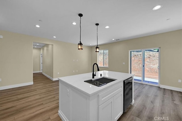 5350 Filbert St, Paradise, CA 95969 - kitchen with black dishwasher, light wood-style flooring, light countertops, recessed lighting, and white cabinetry