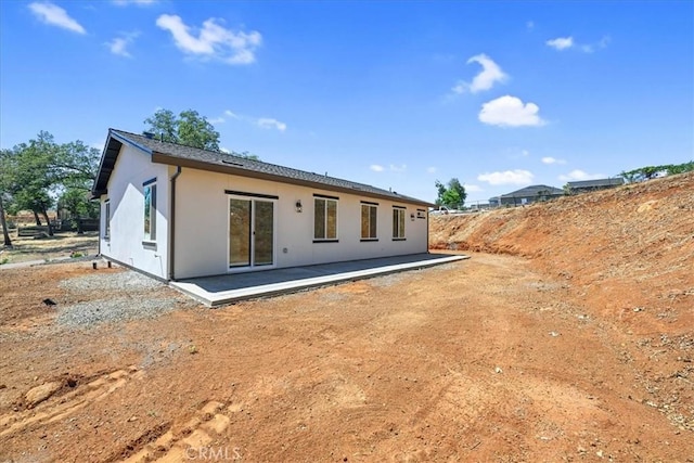5350 Filbert St, Paradise, CA 95969 - back of property with stucco siding and a patio