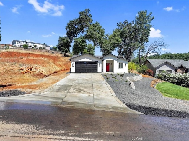 5350 Filbert St, Paradise, CA 95969 - view of front of property with a garage, concrete driveway, and stucco siding