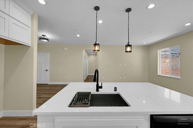 5350 Filbert St, Paradise, CA 95969 - kitchen with wood finished floors, black dishwasher, light stone counters, recessed lighting, and white cabinets