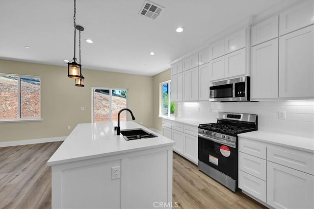 5350 Filbert St, Paradise, CA 95969 - kitchen featuring stainless steel appliances, recessed lighting, light wood finished floors, tasteful backsplash, and light countertops