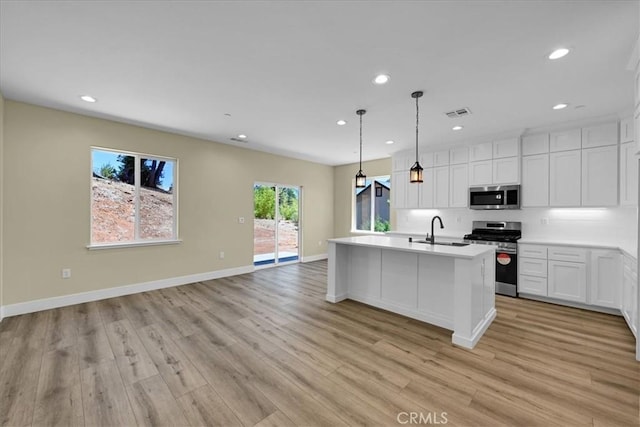 5350 Filbert St, Paradise, CA 95969 - kitchen featuring appliances with stainless steel finishes, recessed lighting, light countertops, light wood finished floors, and white cabinets