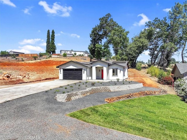 5350 Filbert St, Paradise, CA 95969 - view of front of home featuring driveway, an attached garage, stucco siding, and a front lawn