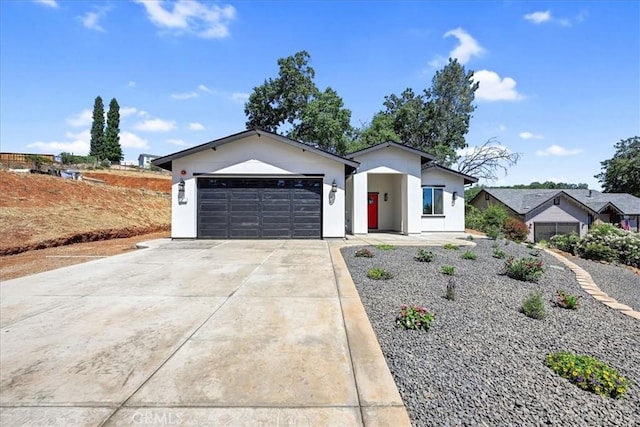 5350 Filbert St, Paradise, CA 95969 - view of front of house with concrete driveway, an attached garage, and stucco siding
