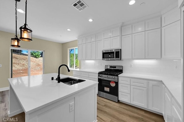 5350 Filbert St, Paradise, CA 95969 - kitchen featuring stainless steel appliances, recessed lighting, light wood finished floors, backsplash, and white cabinetry