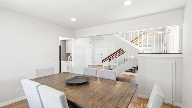 23208 Cuervo Dr, Valencia, CA 91354 - dining room with stairs, light wood finished floors, and recessed lighting