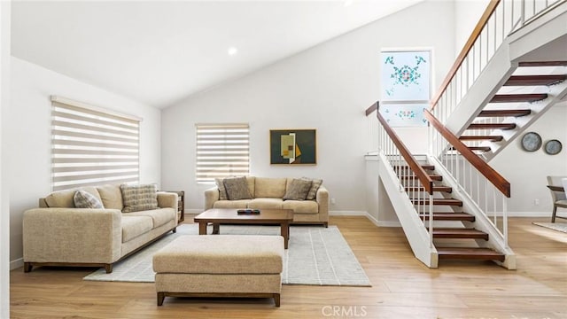 23208 Cuervo Dr, Valencia, CA 91354 - living area featuring high vaulted ceiling, light wood-type flooring, and stairway