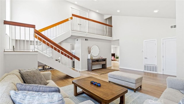 23208 Cuervo Dr, Valencia, CA 91354 - living room with a high ceiling, wood finished floors, stairs, and recessed lighting