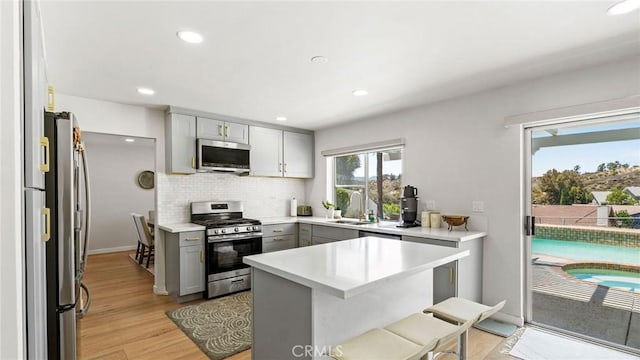 23208 Cuervo Dr, Valencia, CA 91354 - kitchen with stainless steel appliances, gray cabinets, light wood finished floors, light countertops, and recessed lighting