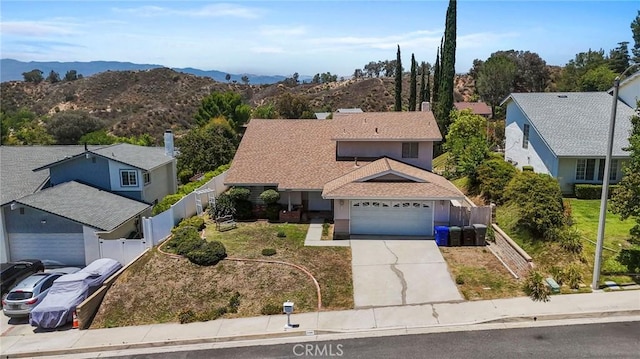 23208 Cuervo Dr, Valencia, CA 91354 - traditional-style home featuring an attached garage, driveway, a mountain view, and a residential view