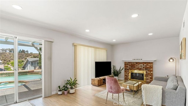 23208 Cuervo Dr, Valencia, CA 91354 - living area with a fireplace, light wood finished floors, and recessed lighting