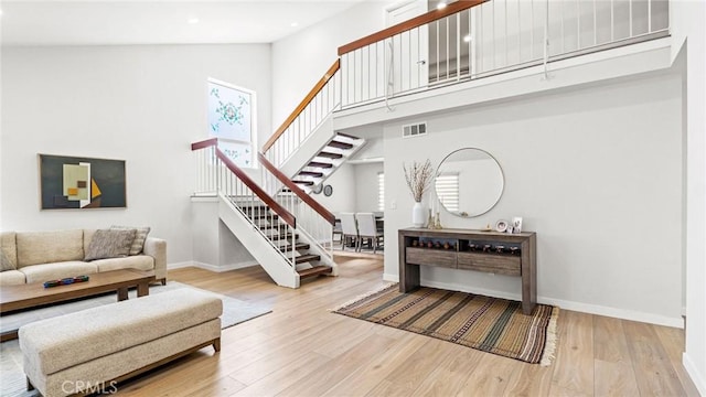 23208 Cuervo Dr, Valencia, CA 91354 - living room with stairway, wood finished floors, high vaulted ceiling, and recessed lighting